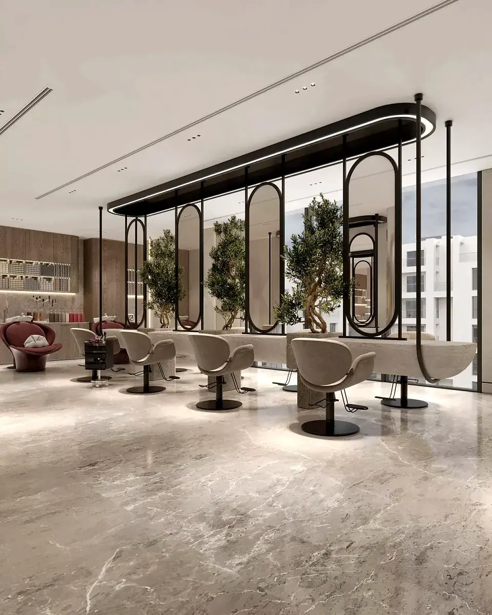 A row of styling stations under arched mirrors, with olive trees along the window